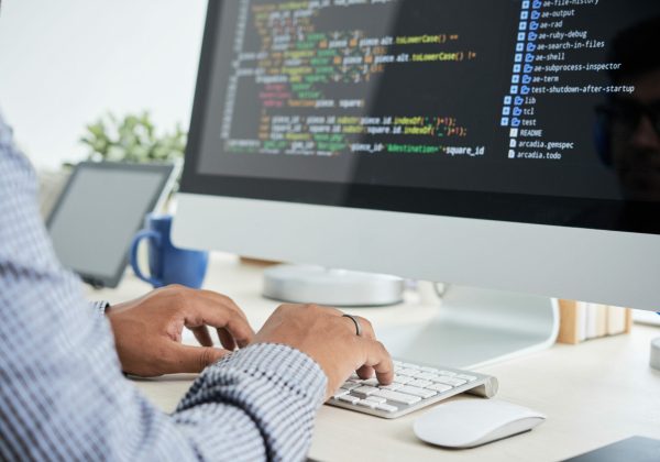 Cropped image of It specialist working on code